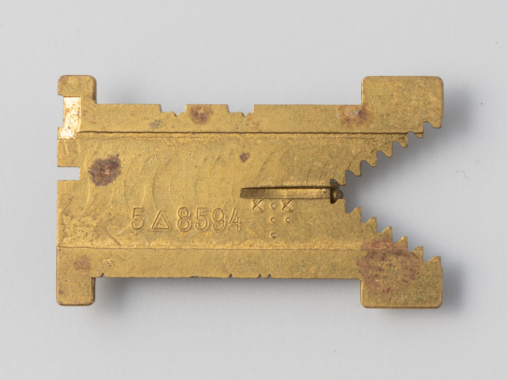 Speldje in de vorm van een matrijs