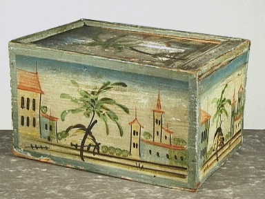 Rechthoekige houten doos met schuifdeksel; décor met huizen en palmen.