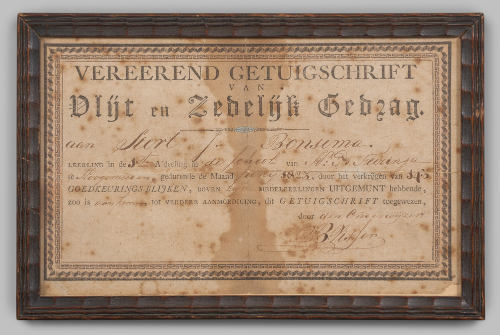 Getuigschrift, ingelijst, achter glas.