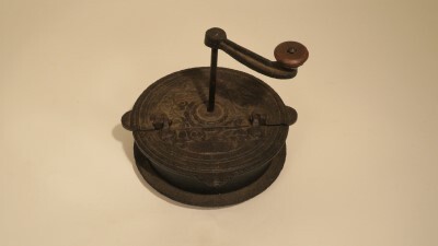 Gietijzeren pan, voorzien van een draaimechanisme, die op de kachel kon worden gezet en waarmee melkbonen werden geroosterd. Draaimechaniek zorgde ervoor dat de bonen niet aanbrandden. 1/3 deel van het deksel is scharnierend. Daarmee konden de bonen in- en uit de pan worden gehaald.