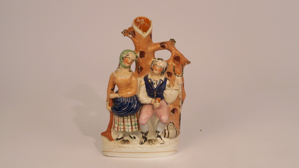 Aardewerken vaas met een boer met een hooivork en een boerin met een hark vast.