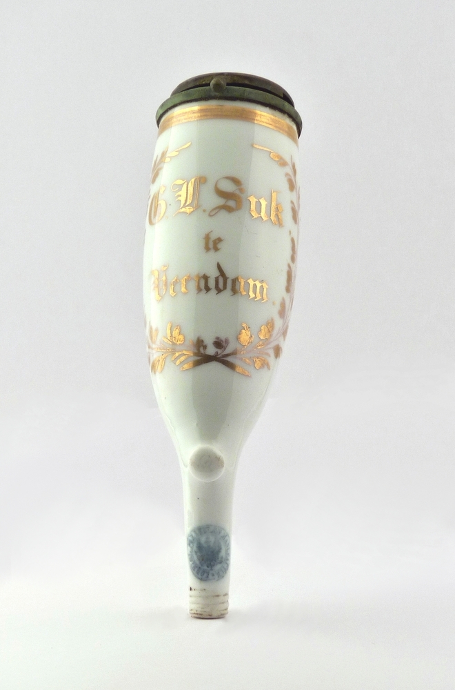 porseleinen pijpekop met opdruk G.L.Suk te Veendam. Geert Lukas Suk, zeeman , geboren 6 januari 1823 te Veendam, overleden 7 september 1873 te Veendam, zoon van Lucas Meint Suk en Jantje Geerts van Dam , getrouwd op 19 maart 1850 te Veendam met Trijntje Hindriks Stutvoet, geboren op 7 maart 1826 te Veendam , overleden 26 maart 1893 te Veendam , dochter van Geesjen Hindriks Puister en Hendrik Roelfs Stutvoet. Geert Lukas Suk komt voor op een monsterrol van 10 februari 1866 als matroos, leeftijd 58 jaar, gage 28, aan boord van de galjoot Zwaantina Thelina.