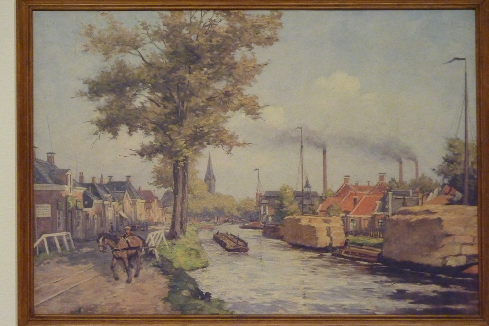 papieren reproduktie op karton in houten lijst voorstellende  schoolplaat De Veenkolonie Oude Pekela rond 1930 door J Gabrielse.