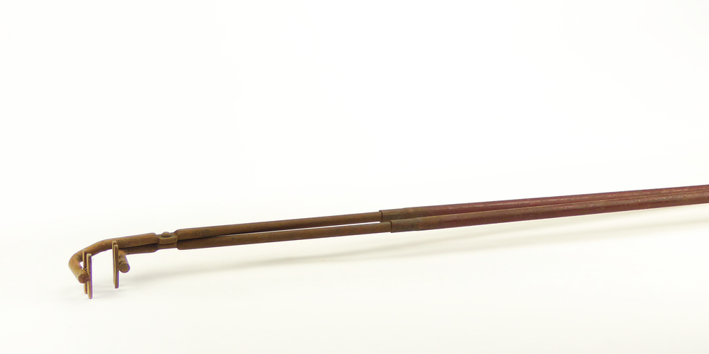 langwerpige tang, uitmondend in een haakse uiteinde, 2 uitsparingen in de vorm van dwarsbalkjes, om een kroes vast te houden.