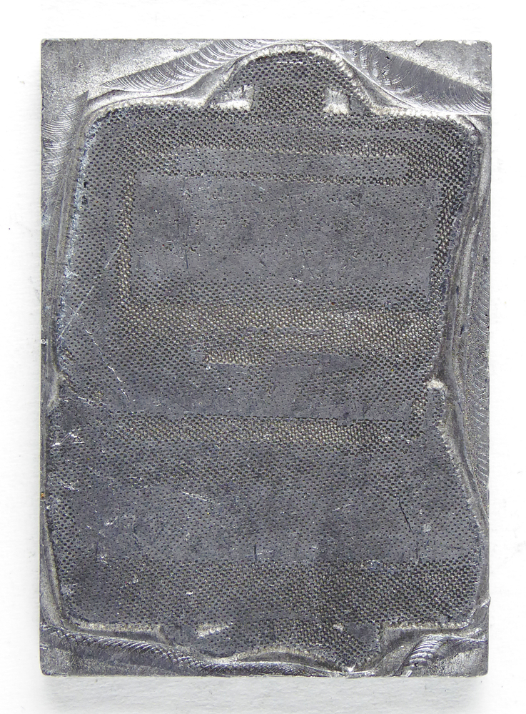 rechthoekige non ferro metalen cliche met afbeelding van een open koffer. afkomstig van kantoorinstallaties Bv Schuur te Veendam