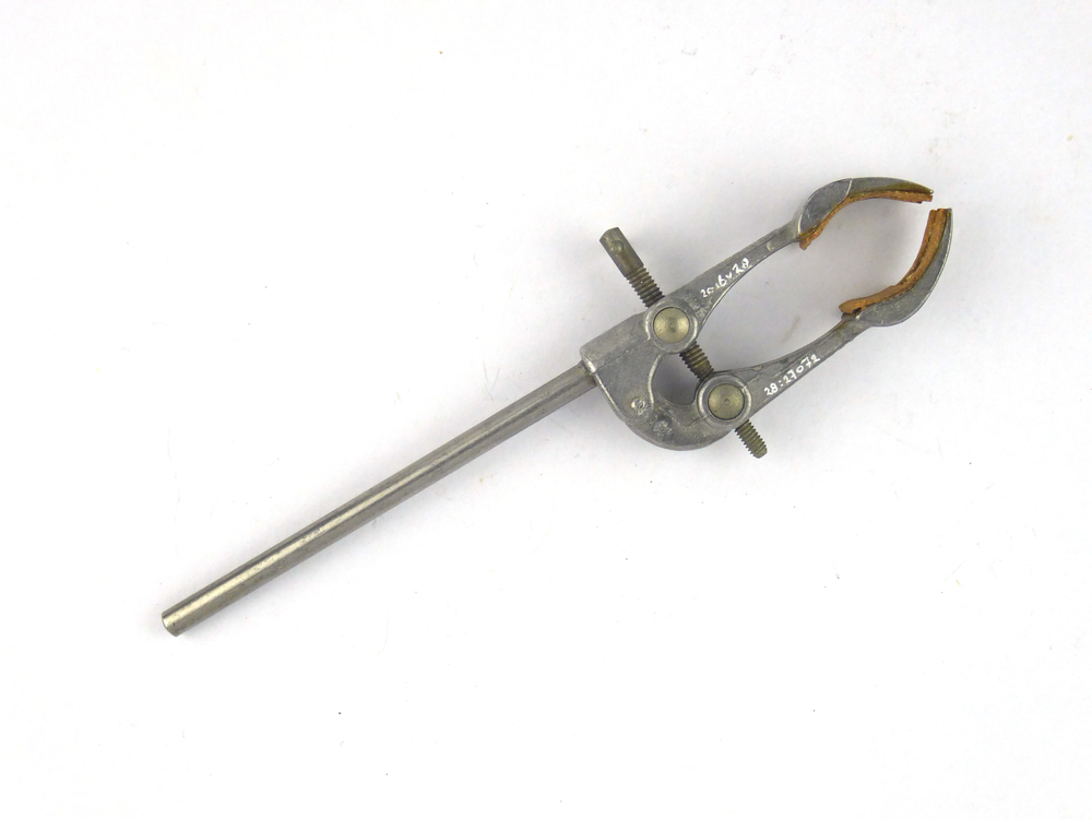 metalen staaf met aan uiteinde 2 armen die verstelbaar zijn door een schroefmechanisme