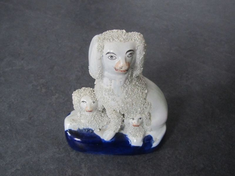 steengoed beeld van poedel met 2 jongen, 1 onder en 1 ernaast, lichaam is bedekt met gruis voor de structuur, op blauwe ondergrond, 11,5 x 5,5 x 14 cm, Staffordshire, 1850 - 1875